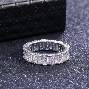 Macro shot of silver eternity ring with alternating rectangular and round crystals