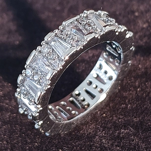 Elegant baguette and round cut zircon eternity ring in polished silver finish