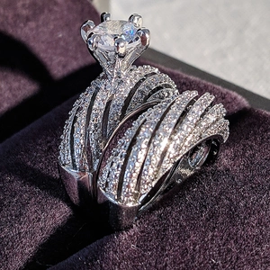 Macro shot of silver six-prong cubic zirconia ring set in a purple velvet jewelry box