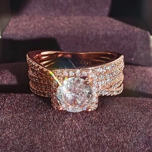 Detailed close-up of a rose gold layered ring with micro-pave zircons and a large centerpiece