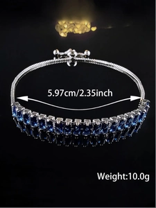 Macro shot of adjustable silver bracelet with rectangular blue crystals on a mirror background