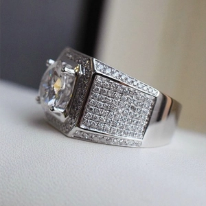 Macro shot of silver ring with large round centerpiece and pavé micro-inlaid diamonds
