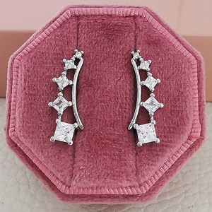 Silver square zircon ear studs with gradient size crystals in a pink velvet jewelry box