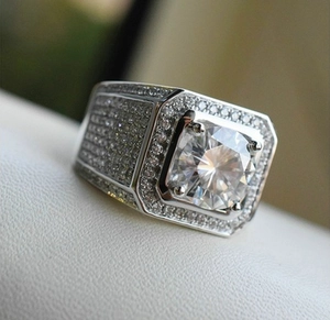 Macro side view of a wide silver square-cut man ring with full pavé setting diamonds