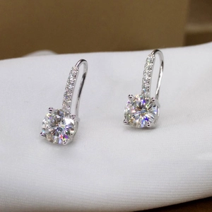 Macro shot of silver leverback earrings with round brilliant-cut stones and pavé accents