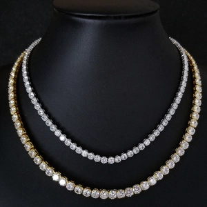 Detailed close-up of 4mm tennis necklaces in gold and silver finish on a neck model