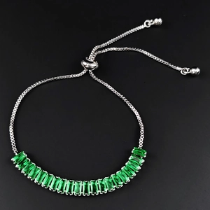 Macro shot of silver box chain with emerald green rectangle stones and adjustable slide