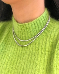 Detail of double-layered silver tennis necklace with sparkling cubic zirconia on a model