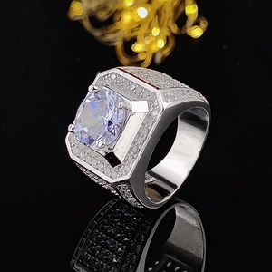Luxurious men's silver ring with central diamond and pave-set crystals on black mirror