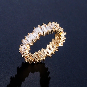 Luxuriöser goldener Eternity-Ring mit rechteckigen AAA-Zirkonia auf schwarzem Grund