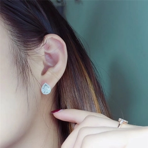 Close-up of sparkling pink zircon teardrop earrings worn by a model for a sweet look