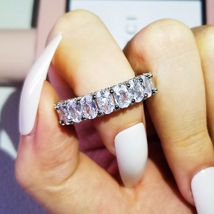 Macro shot of a silver engagement ring set with shimmering oval-cut cubic zirconia stones