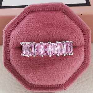 Detail of luxury pink rectangular zircon ring set in silver on velvet jewelry box