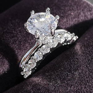 Elegant round brilliant cut engagement ring set with six-prong setting on purple velvet