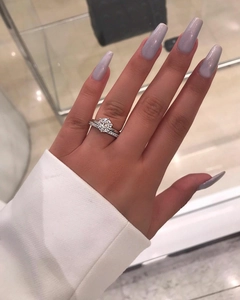 Sparkling silver engagement ring set with round solitaire and pave diamond bands