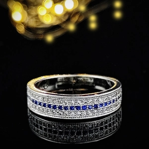 Elegant silver engagement ring with blue sapphire center and multi-row diamond pavé