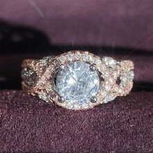 Vue macro d'une bague bicolore entrelacée avec halo de zircon rond et pavé de cristaux