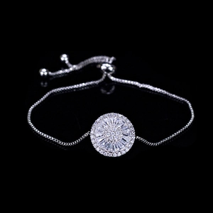 Sparkling silver bolo bracelet with a central radial zircon charm on black background