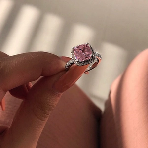 Luxury silver ring featuring a square pink gemstone with a diamond halo and pavé band