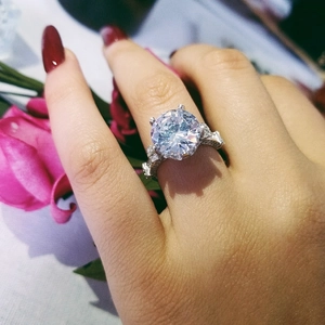 Detailed view of luxury round-cut solitaire engagement ring with side accent diamonds