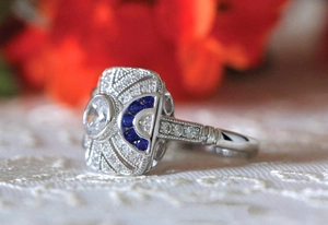 Art Deco vintage ring close-up featuring blue sapphire accents and zircon pavé detailing