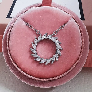 Silver sunflower pendant necklace with marquise-cut zircons in a pink velvet gift box