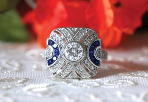 Macro view of vintage silver ring with central zircon and blue accent stones