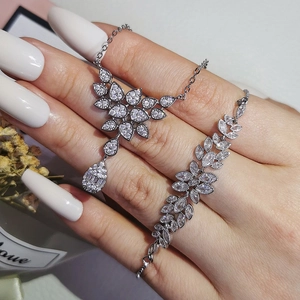 Elegant silver bridal jewelry set with marquise cut stones and leaf charms for weddings