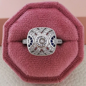 Vintage silver ring with round zircon and blue sapphire accents on pink velvet gift box