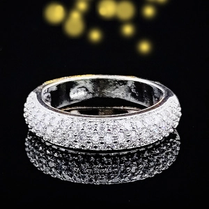 Luxury wide band ring with silver finish and multi-row pave crystals on black background