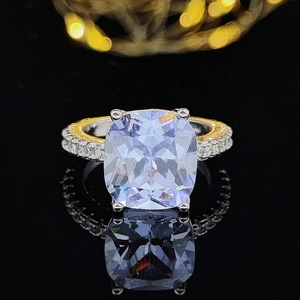 Detailed macro of a two-tone engagement ring with a large rectangular cut centerpiece