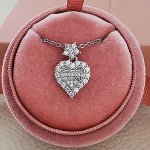 Elegant silver heart necklace with zircon stones in a pink velvet jewelry box for gifting