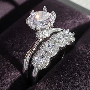 Classic silver six-prong solitaire engagement ring set with micro-pave wedding band