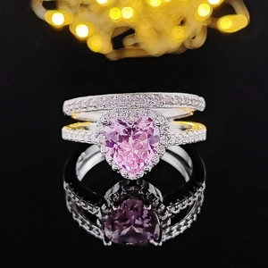 Elegant heart-shaped pink diamond ring set in silver finish with pavé stones and reflection