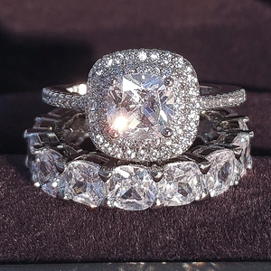 Luxury cushion cut halo engagement ring set with eternity band in polished white gold