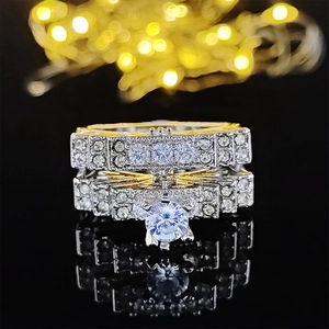 Two-piece bridal ring set with light blue round stone and pavé diamonds in two-tone finish