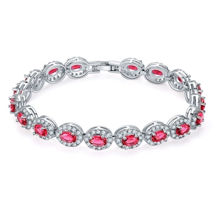Elegant silver tennis bracelet with oval red gemstones and white zircon halo on white background