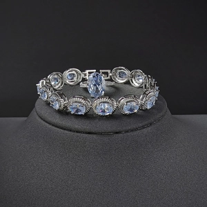 Elegant silver jewelry set featuring a blue gemstone bracelet and matching oval ring