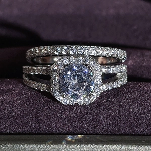 Detail view of two-piece luxury ring set with round center stone and octagonal halo