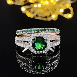 Luxury silver ring set featuring a large oval green gemstone and pavé diamonds