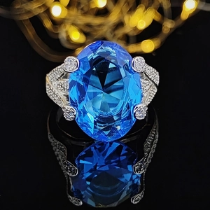 Exquisite 18k white gold plated engagement ring with large oval blue topaz and pavé diamonds