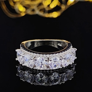 Silver S925 ring with five circular sparkling zircons on a reflective black surface