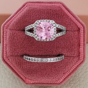 Set di anelli da sposa rosa con taglio a cuscino in una scatola di velluto rosa