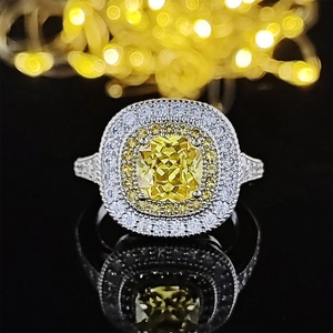 Luxury cushion cut yellow gemstone ring with double halo diamond setting on black background
