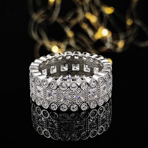 Elegant silver eternity ring with rows of sparkling pavé-set round and square zircons
