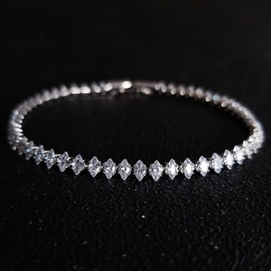 Macro shot of marquise-cut crystal stones on a polished silver-tone bracelet