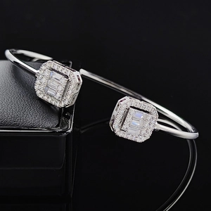 Elegant adjustable open cuff bracelet with emerald-cut zircon halo settings on black background