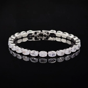 Elegant silver tennis bracelet with oval-cut zircons and secure clasp on black background