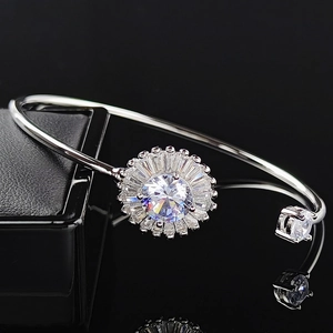 Silver open adjustable cuff bracelet featuring a large sunflower-shaped zircon centerpiece