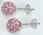 Macro shot of pink crystal sphere stud earrings with secure butterfly backs